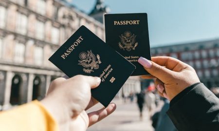 Best vacation spots in the US - Tourists showing passports.