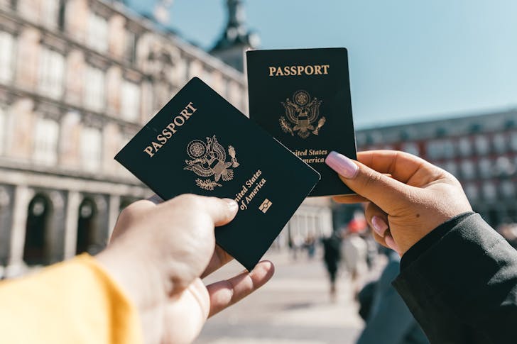 Best vacation spots in the United States - Tourists showing passports.