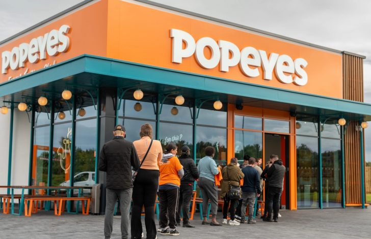 How does Popeyes decide where to build a store?