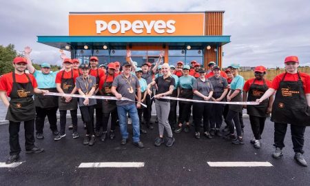 How does Popeyes decide where to build a store?